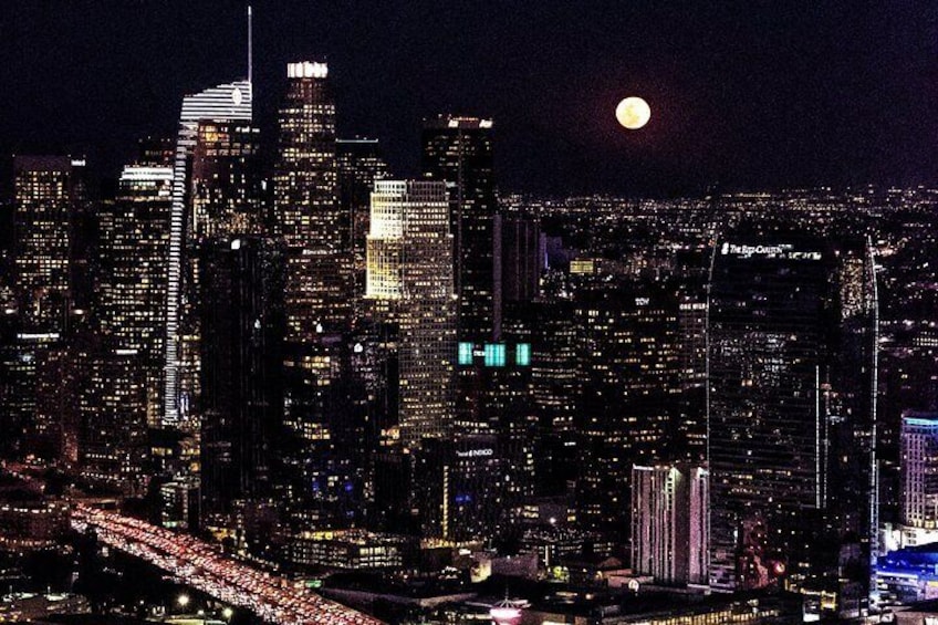 Downtown LA at night with a full moon