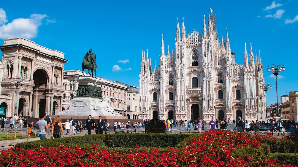 Exterior view of Duomo di Milano with rose garden seen in front.