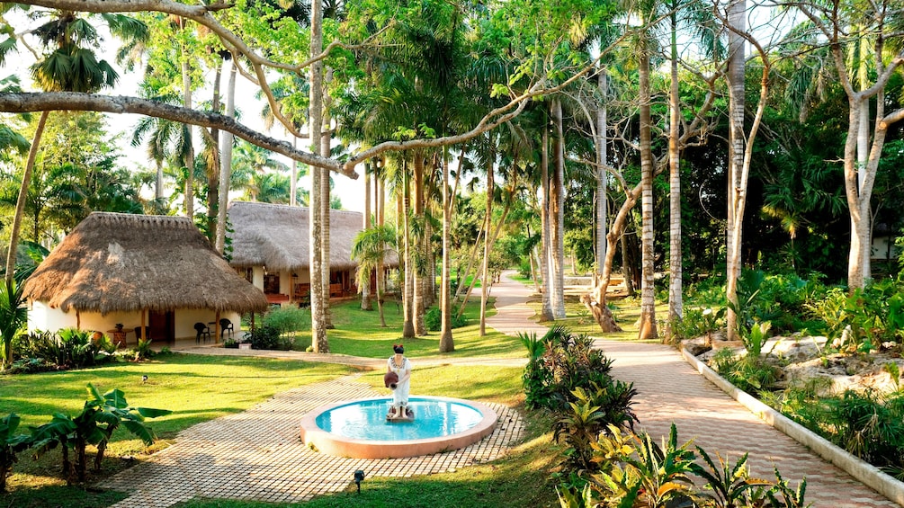 Bungalows of the Mayaland resort and a fountain along the path