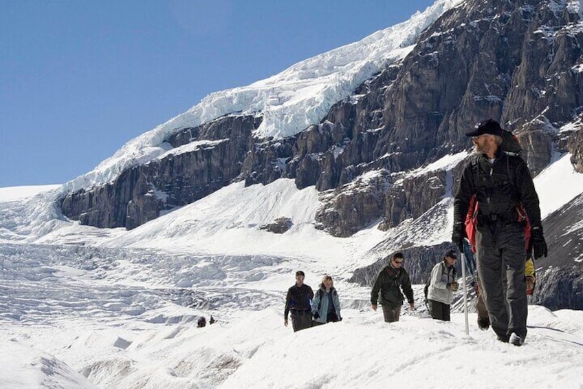 Hiking down the glacier with the impressive icefalls in the background