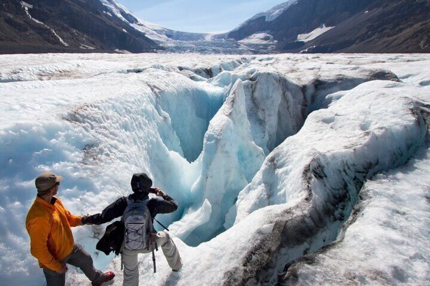 Guide safely showing a guest the ice formations
