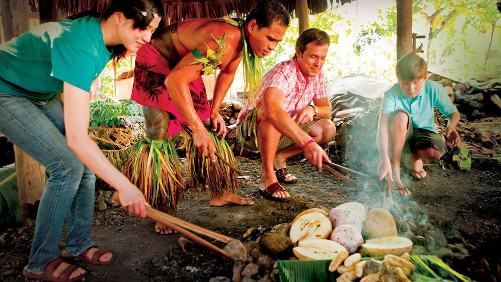 Participants moving stones around a fire