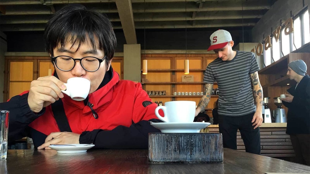 Man sipping coffee at the Pioneering Eastside Roasters Coffee Tour in Portland 