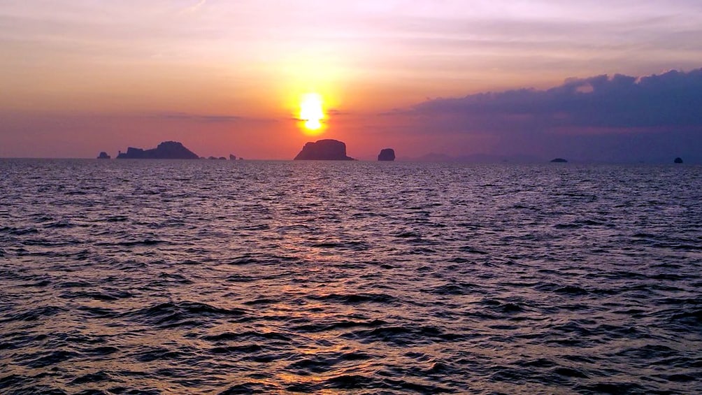 sun setting into the horizon in Thailand