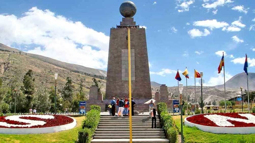 walking up the steps to a monument in Quito