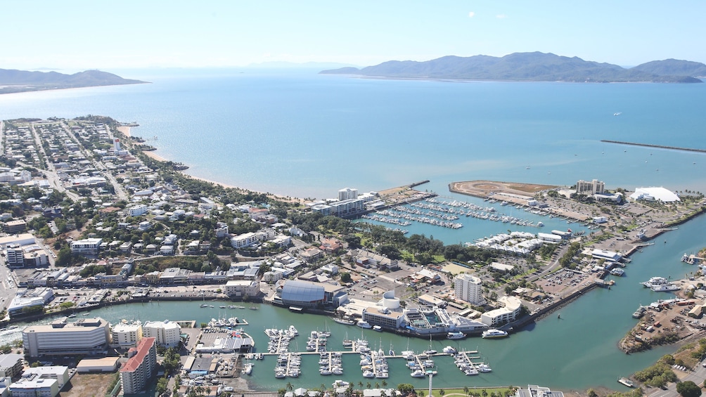 Aerial shot of coast, with several boating ports in view.