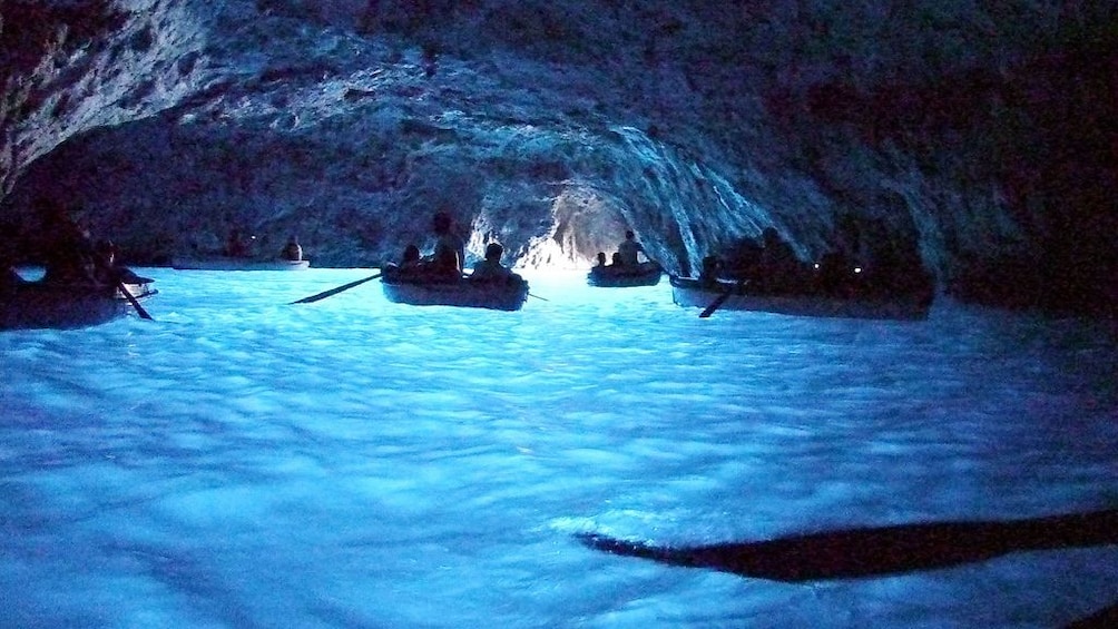 People passing through coastal cave in Italy
