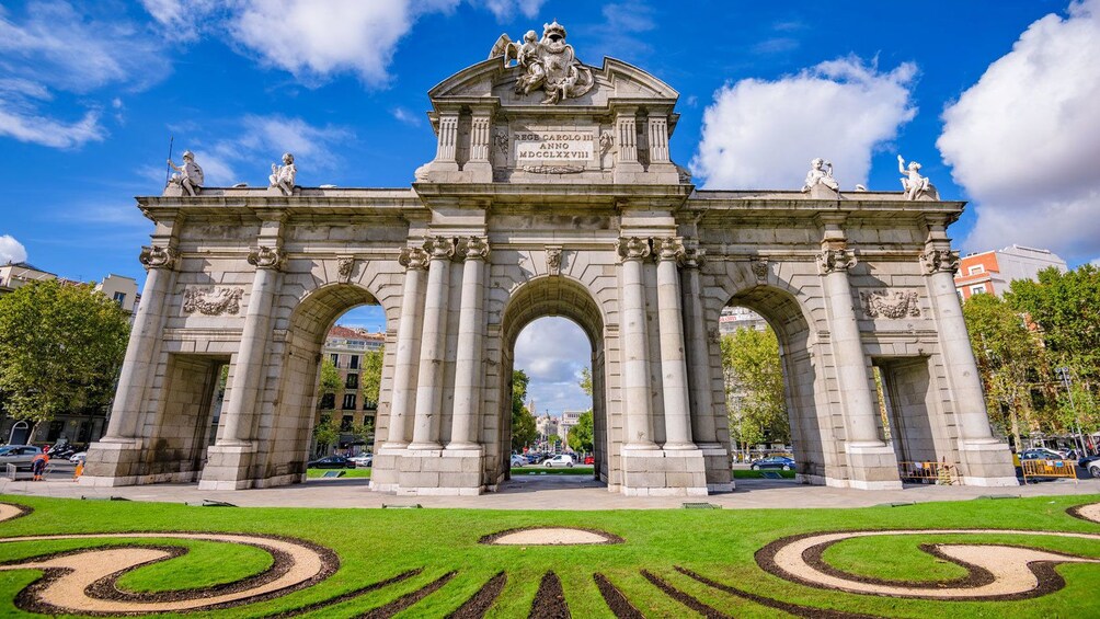 patterned garden in front of a grand archway in SPain