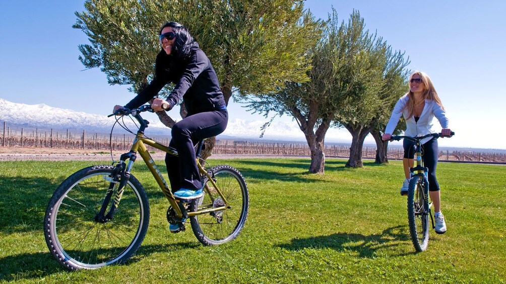 women riding bikes on freshly cut grass in Argentina