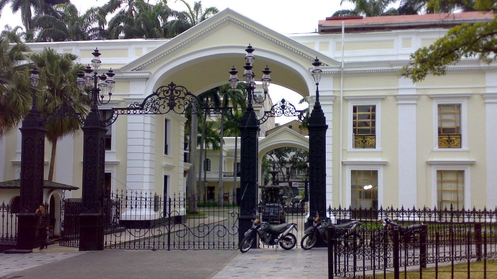 Historic yellow building and wrought iron fence in Caracas