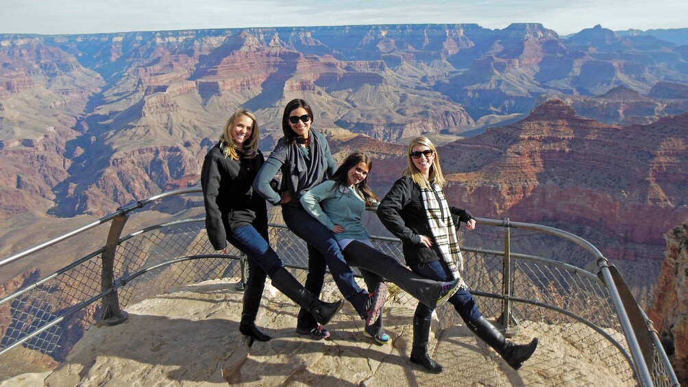 Friends posing for photo at overlook of Grand Canyon