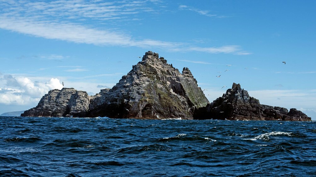 waves against tall jagged rocks in Ireland