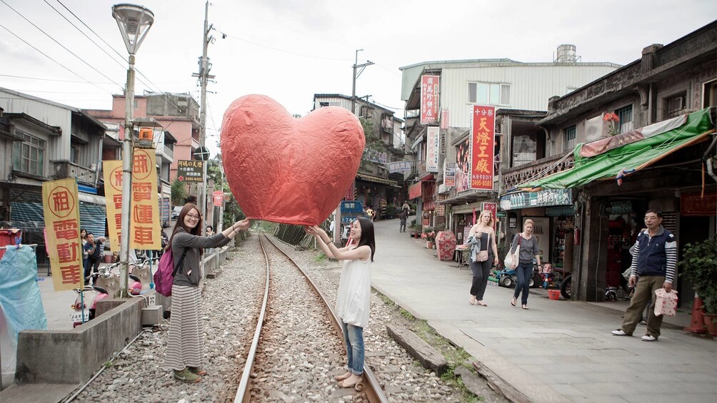 Ladies having fun on the Pingxi Sky Lantern & Old Street Walk tour in Taipei 