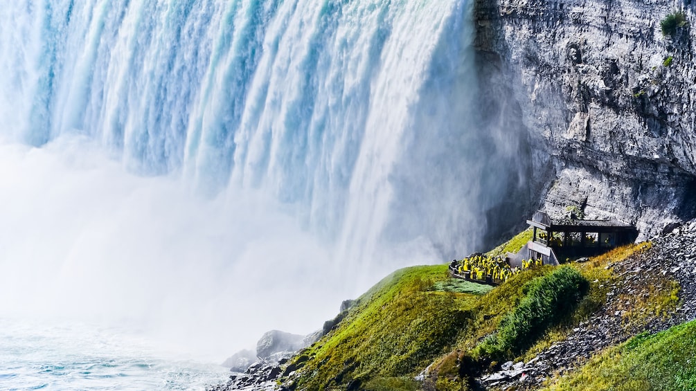 View from afar of people on observation deck at Niagra falls
