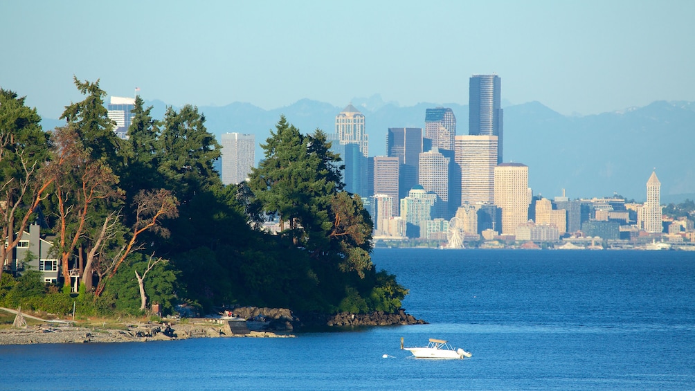 Aerial view of Puget Sound with Seattle skyline in the distance.