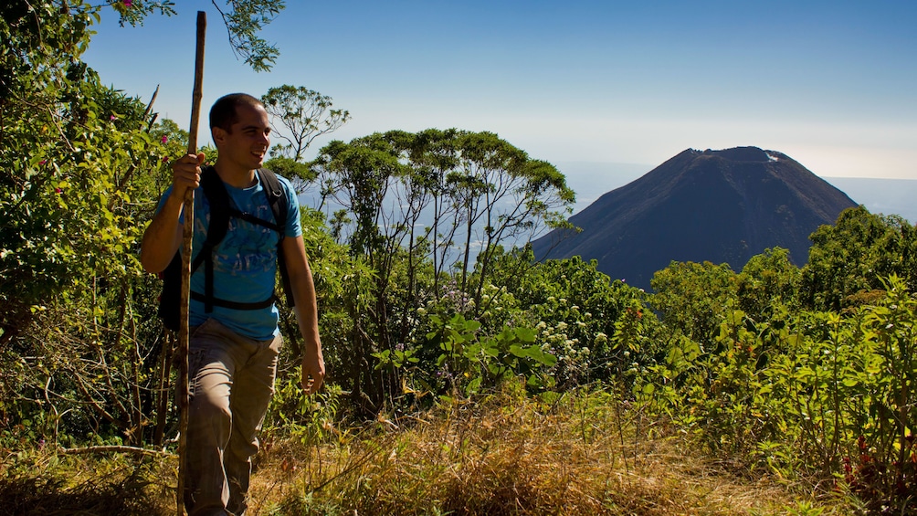 Show item 3 of 5. Man hiking next to Volcano in El Salvador