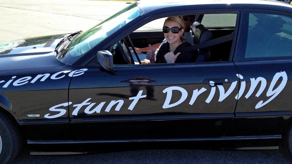 Show item 4 of 5. woman ready to take the wheel in a stunt car in Ontario