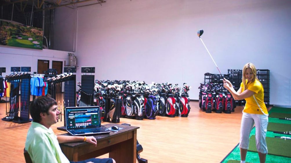 Interior view of rental shop with several golf club available.