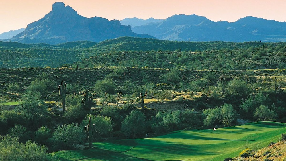 Beautiful landscape view of golf course with mountains in the distance.