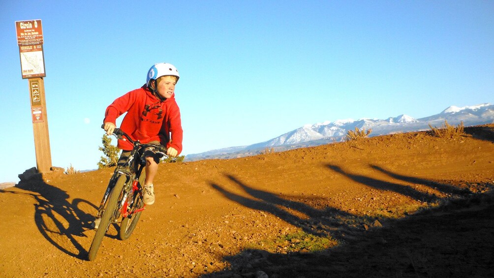 child riding a bike in the dry dirt in Green River