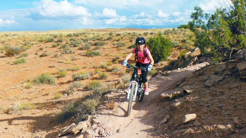 girl riding bike through a narrow trail in Green River