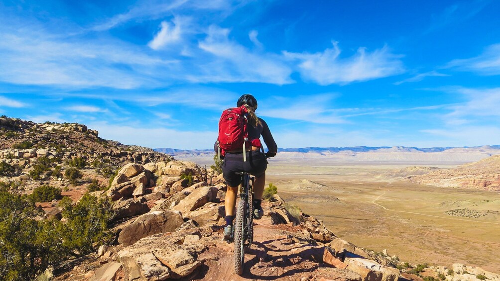 Cyclist shown from behind riding on bike trail in North Klondike.