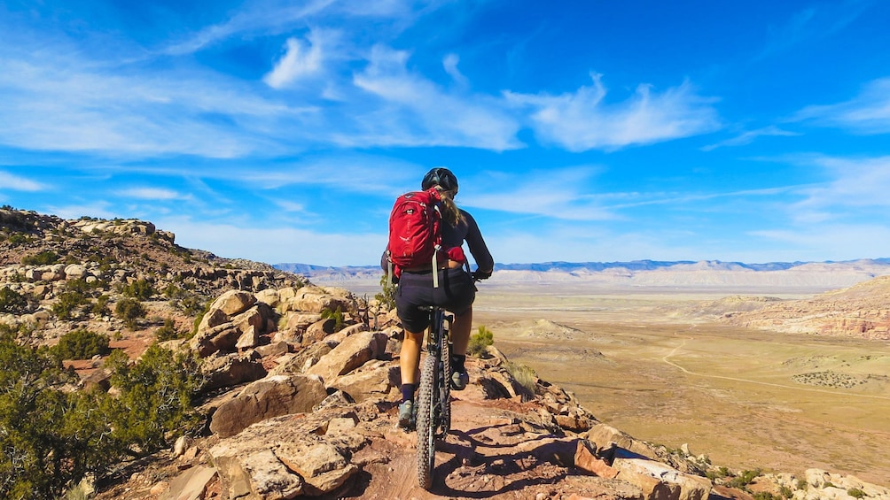 Cyclist shown from behind riding on bike trail in North Klondike.