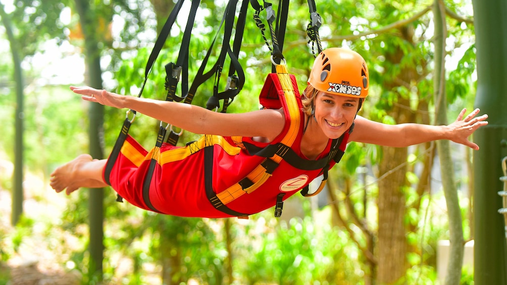 Woman on a zip line through the jungle