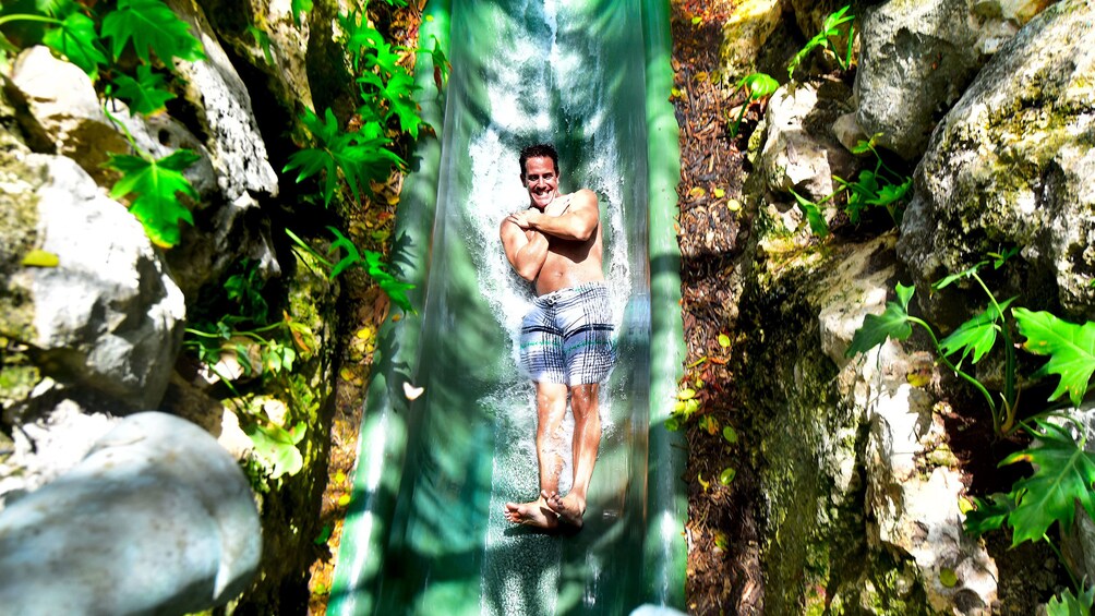 Man goes down a water slide