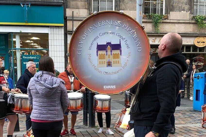 Stopping to watch the City of Inverness Pipe Band practice