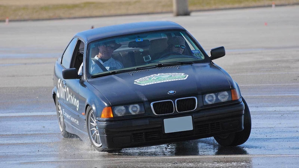 Show item 1 of 5. black stunt car drifting on the wet tracks in Ontario