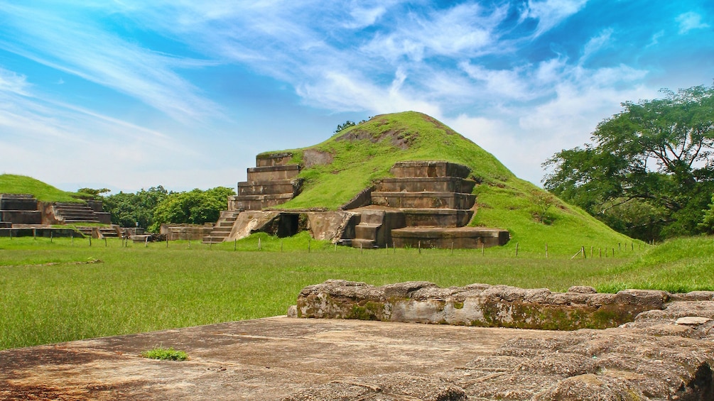Show item 3 of 5. Mayan pyramid covered in grass