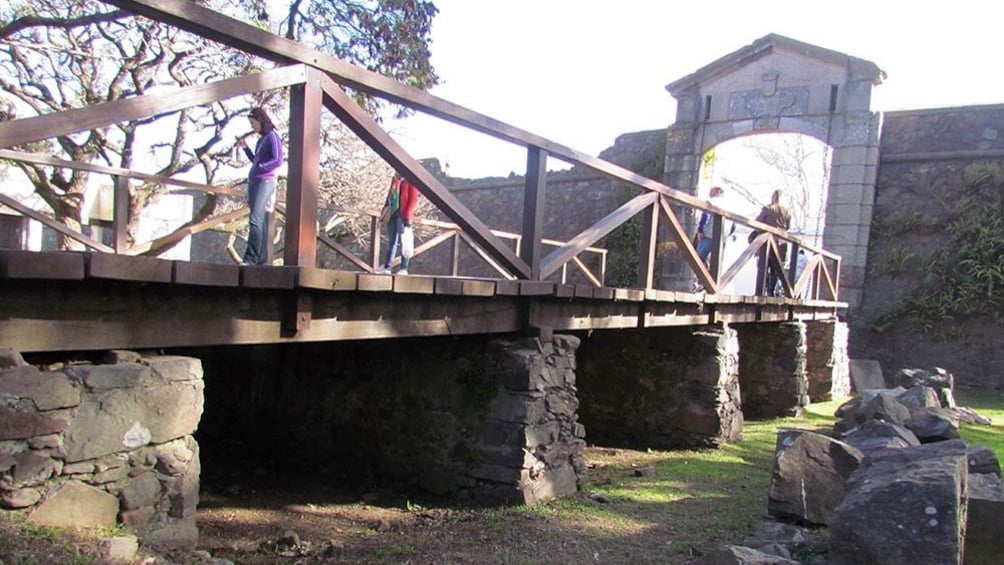 Guests walking across a bridge on the Colonia Day Tour in Uruguay