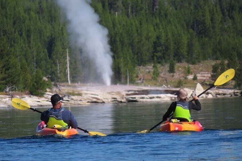 Watching geysers erupt while paddling on Yellowstone Lake with Yellowstone Hiking Guides.