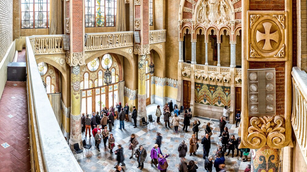 Tourists looking at the beautiful interior of a cathedral in Sant Pau