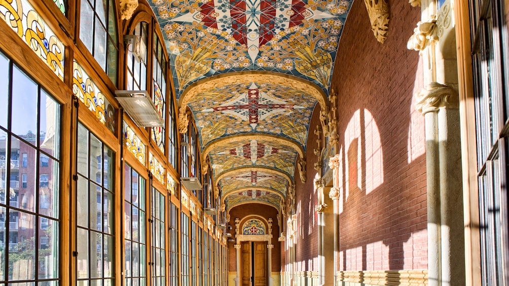 Hallway lined with windows and an ornate ceiling in a cathedral in Sant Pau