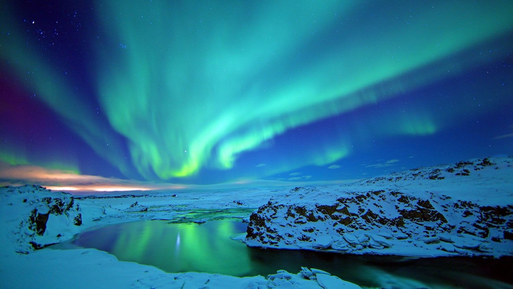 the northern lights reflecting from the a lake in Reykjavik