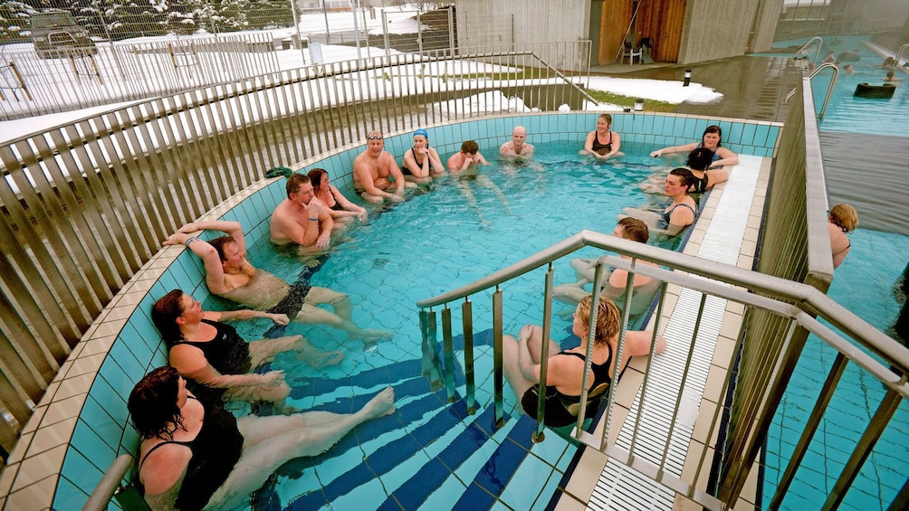 group enjoying a warm outdoor pool in Reykjavik