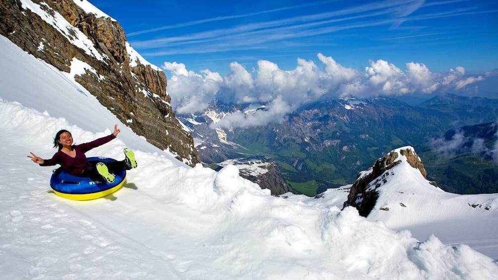 woman sledding down the mountain in Switzerland