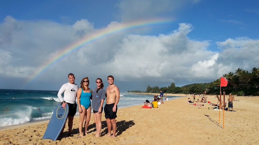 Family standing on beach in Oahu