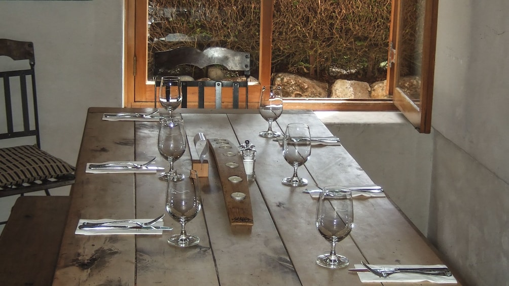 Show item 5 of 5. View of prepared dining table with silverware and wine glasses.