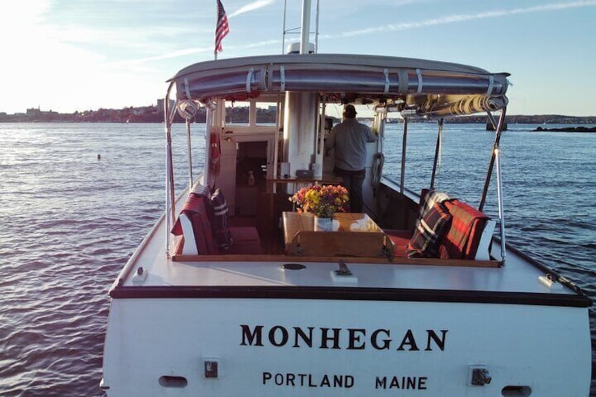 MONHEGAN is equipped with a finely finished wooden table in between cushioned "booth style" benches