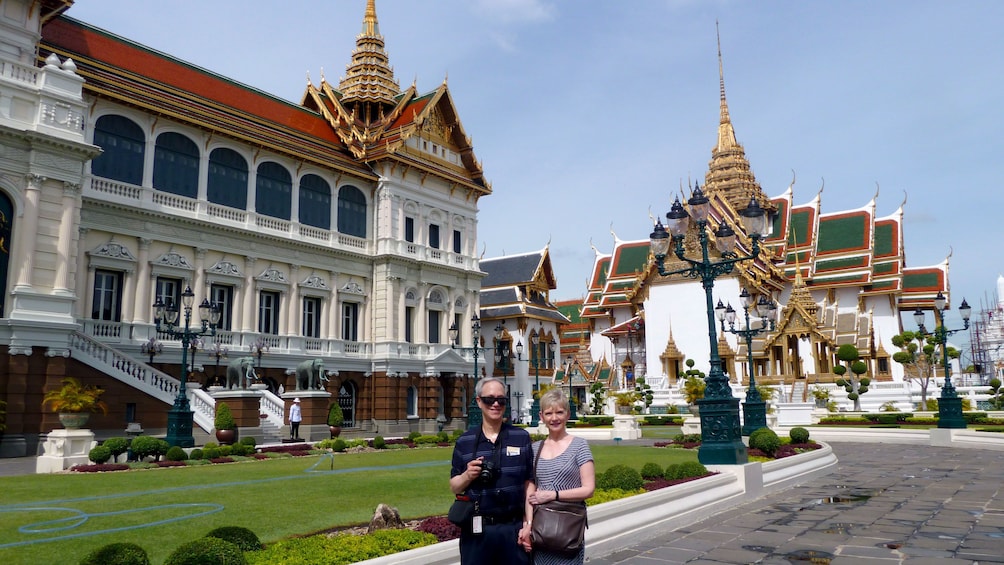 Two people outside the grand palace in bangkok