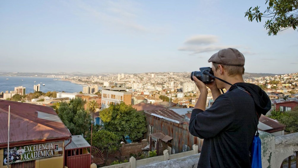 Man taking a photo of the city in Valparaiso