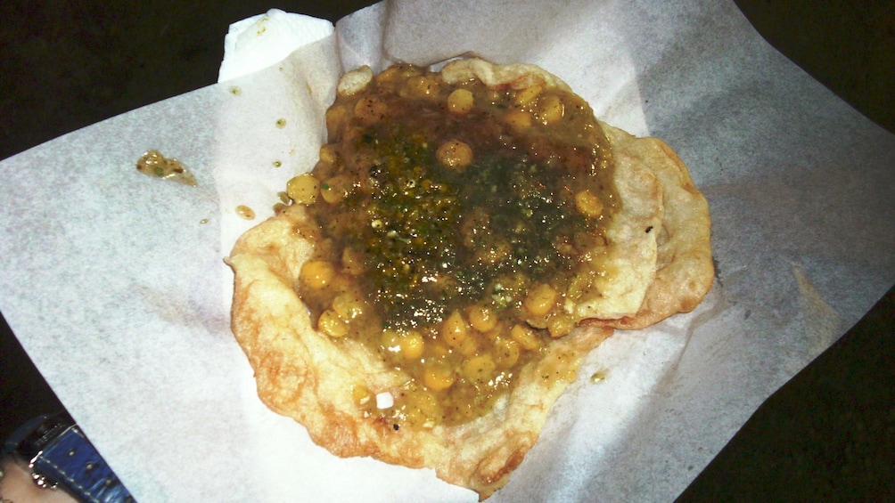 A handful of food and bread on wax paper