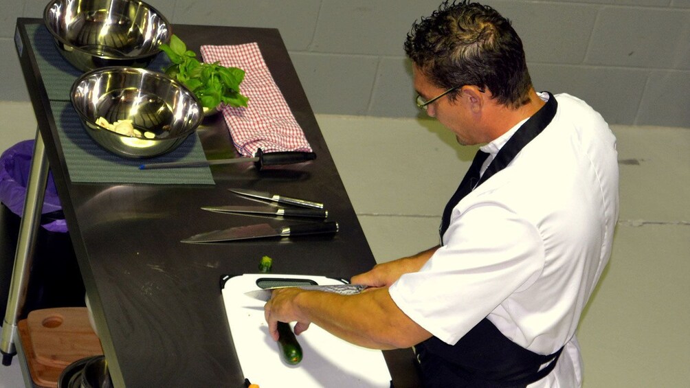 Show item 2 of 5. Instructor demonstrating with knife