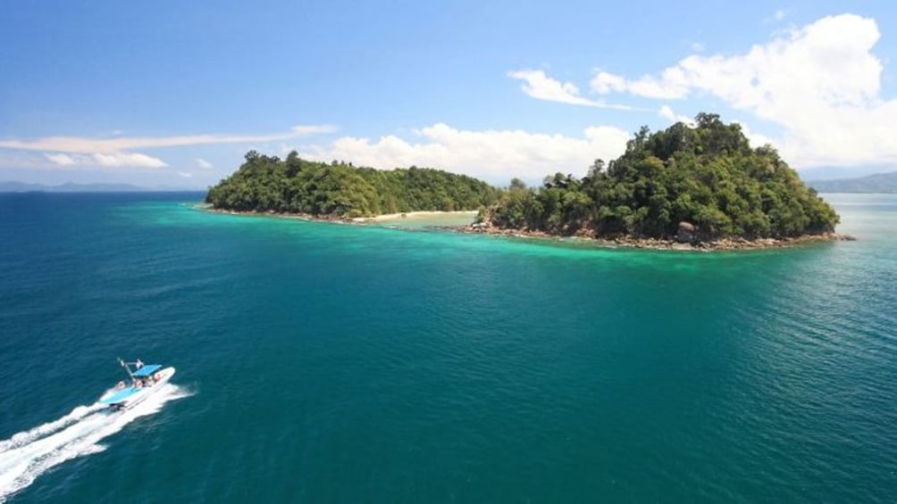 Show item 1 of 5. boat approaching island in malaysia