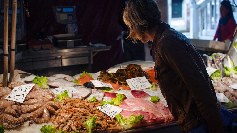 Woman looking at seafood on ice