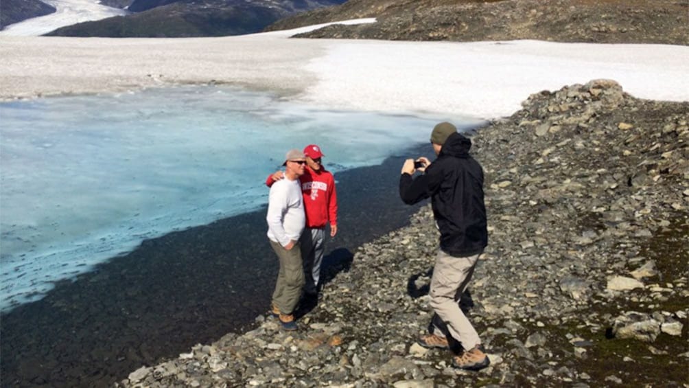 Group on the shore of a glacier lake in Anchorage