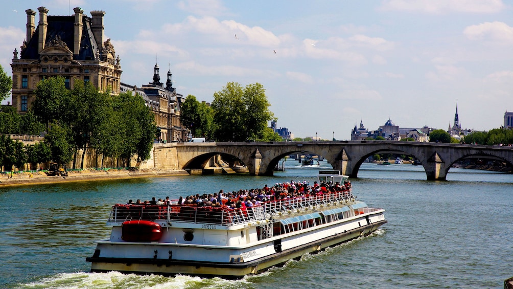 Bateaux-Mouches Capital Sightseeing Cruise boat traveling down canal in Paris, France